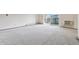 Bright living room with carpet, opening to a balcony with abundant natural light at 9625 E Center Ave # 5C, Denver, CO 80247