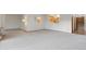 Bright living room featuring neutral carpeting, and a pass through to the kitchen at 9625 E Center Ave # 5C, Denver, CO 80247