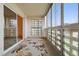 Enclosed sunroom with sliding door and multiple windows offering abundant natural light at 9625 E Center Ave # 5C, Denver, CO 80247