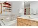 Bright bathroom featuring a large bathtub and wood vanity with a sink at 1133 Northridge Dr, Erie, CO 80516