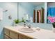 Charming bathroom with a vanity, mirror, and soft blue walls at 1133 Northridge Dr, Erie, CO 80516