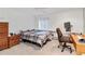 Comfortable bedroom featuring a cozy bed, desk area, and window, perfect for relaxation and productivity at 1133 Northridge Dr, Erie, CO 80516