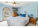 Bright bedroom features a ceiling fan, window with blinds, and built-in shelving for storage and decor at 1133 Northridge Dr, Erie, CO 80516