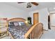 Bright bedroom with wood bed frame, ceiling fan and neutral decor at 1133 Northridge Dr, Erie, CO 80516