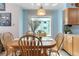 Cozy dining area featuring a wooden table, chairs, pendant lighting, and large windows at 1133 Northridge Dr, Erie, CO 80516