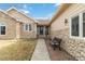 Inviting entrance featuring stone accents, a charming bench, and a well-lit walkway to the front door at 1133 Northridge Dr, Erie, CO 80516