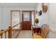 Welcoming entryway with wood accents, a decorative table, and a staircase leading to the upper level at 1133 Northridge Dr, Erie, CO 80516