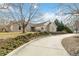 Charming home featuring stone accents, a well-maintained lawn, and a curved driveway leading to the residence at 1133 Northridge Dr, Erie, CO 80516