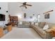Bright living room with vaulted ceilings, a comfortable sofa, and a bookshelf filled with books at 1133 Northridge Dr, Erie, CO 80516