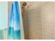 Shower with tiled walls and a blue patterned shower curtain at 1133 Northridge Dr, Erie, CO 80516