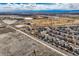 High aerial view of homes with a golf course and distant mountain views on a sunny day at 8768 Foxfire St, Firestone, CO 80504