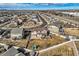 Aerial view of a neighborhood street featuring well maintained homes and green spaces, with mountain views at 8768 Foxfire St, Firestone, CO 80504