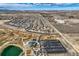 Wide aerial view of a planned community including clubhouse, pool, parking, and open space at 8768 Foxfire St, Firestone, CO 80504