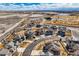 Aerial image of a neighborhood with well-manicured lawns and mature trees, close to golf course and community amenities at 8768 Foxfire St, Firestone, CO 80504