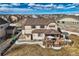 Aerial view of house with large back deck, grassy backyard, and surrounding neighborhood at 8768 Foxfire St, Firestone, CO 80504