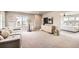Spacious basement area with a gray couch, large window, and view to the main bedroom at 8768 Foxfire St, Firestone, CO 80504