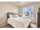 Cozy bedroom with a large window, plush bedding, and a ceiling fan for added comfort at 8768 Foxfire St, Firestone, CO 80504