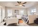 Charming bedroom with two twin beds, a ceiling fan, and plenty of natural light at 8768 Foxfire St, Firestone, CO 80504
