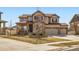 Charming two-story home with stone accents, well-maintained lawn, and three-car garage at 8768 Foxfire St, Firestone, CO 80504