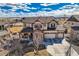 Aerial view of house with three-car garage, stone accents, and manicured front yard at 8768 Foxfire St, Firestone, CO 80504