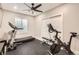Finished basement gym with workout equipment, including a treadmill and a stationary bike at 8768 Foxfire St, Firestone, CO 80504