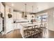 Well-equipped kitchen features a granite island, pendant lighting, and stainless steel appliances at 8768 Foxfire St, Firestone, CO 80504