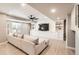 Basement living room boasts large sectional sofa, mounted television, and recessed lighting at 8768 Foxfire St, Firestone, CO 80504