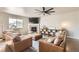 Bright living room featuring a fireplace, stylish shelving, and comfortable seating at 8768 Foxfire St, Firestone, CO 80504
