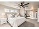 Serene main bedroom with a king-size bed, an adjacent office space, and natural light at 8768 Foxfire St, Firestone, CO 80504