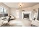 Comfortable office space featuring a fireplace, bright lighting, and a door to another room at 8768 Foxfire St, Firestone, CO 80504