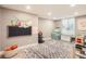 Basement playroom with gray and white carpet, toys, and chalkboard wall at 8768 Foxfire St, Firestone, CO 80504
