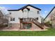 Spacious backyard with a deck, patio, lush lawn, and a charming exterior view of the home at 20650 Parker Vista Cir, Parker, CO 80138