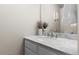 Bathroom vanity area with marble countertop, white cabinets, brushed nickel faucet and decorative accessories at 20650 Parker Vista Cir, Parker, CO 80138