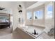 Bathroom featuring a large tub with tile surround and large window providing natural light at 20650 Parker Vista Cir, Parker, CO 80138