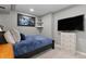 A cozy bedroom featuring blue bedding, sports decor, a mounted television, and a white dresser at 20650 Parker Vista Cir, Parker, CO 80138