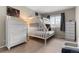 Bedroom featuring a bunk bed with white frame, a window with blinds, and a dresser at 20650 Parker Vista Cir, Parker, CO 80138