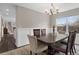 Elegant dining room with wainscoting, modern lighting, and a large window with scenic views at 20650 Parker Vista Cir, Parker, CO 80138