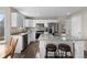 Modern kitchen with white cabinets, granite countertops, stainless steel appliances, and an island with seating at 20650 Parker Vista Cir, Parker, CO 80138