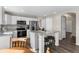 Well-lit kitchen features white cabinets, stainless appliances, granite counters, and center island at 20650 Parker Vista Cir, Parker, CO 80138