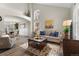 Spacious living room with hardwood floors, neutral tones, and an open layout to the dining area at 20650 Parker Vista Cir, Parker, CO 80138