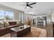 Open living area with fireplace, leather couch, lots of light, and connected kitchen and breakfast nook at 20650 Parker Vista Cir, Parker, CO 80138