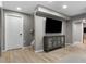 Cozy living room with hardwood floors, gray walls, and a modern entertainment center and TV at 20650 Parker Vista Cir, Parker, CO 80138