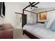 Relaxing primary bedroom features a canopy bed, ensuite bathroom, and a ceiling fan at 20650 Parker Vista Cir, Parker, CO 80138
