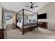 Spacious primary bedroom with a canopy bed, ceiling fan, and large windows for ample natural light at 20650 Parker Vista Cir, Parker, CO 80138