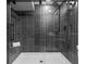 Modern shower featuring dark marble-like tile, a rainfall showerhead, and a built-in bench at 20650 Parker Vista Cir, Parker, CO 80138