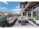Relaxing back patio area with comfortable seating, a fire pit, and open sky views at 9741 Taylor River Cir, Littleton, CO 80125