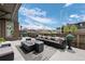 Stylish back patio with modern furniture, a fire pit, and views of the neighborhood at 9741 Taylor River Cir, Littleton, CO 80125