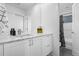 Bright, renovated bathroom featuring a marble countertop, white vanity, and updated fixtures at 9741 Taylor River Cir, Littleton, CO 80125
