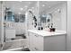 Bright bathroom featuring a glass-enclosed shower, modern fixtures, and a white vanity with lots of storage at 9741 Taylor River Cir, Littleton, CO 80125