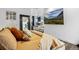 Bright bedroom with a full-length mirror and view into the sun room, featuring light-colored decor and lots of natural light at 9741 Taylor River Cir, Littleton, CO 80125